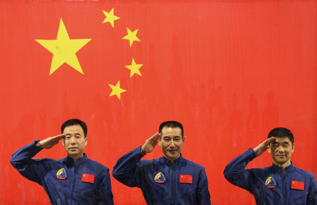 Chinese astronauts Jing Haipeng (L), Zhai Zhigang (C) and Liu Boming salute in front of a Chinese national flag during a news conference at the Jiuquan Satellite Launch Center in Gansu province. China readied for its next leap into space on Thursday, with the Shenzhou VII craft primed to blast off with three astronauts and plans for a first space walk that will underscore the country's technological ambitions.