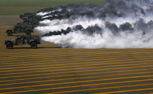 Military vehicles smoke the tarmac of the Chingchuankang Air Force Base during a Han Kuang exercise drill in Taichung. Taiwan launched a week of low-key military drills on Monday, axing a live-fire display as the island seeks better ties with its wary political rival, China.
